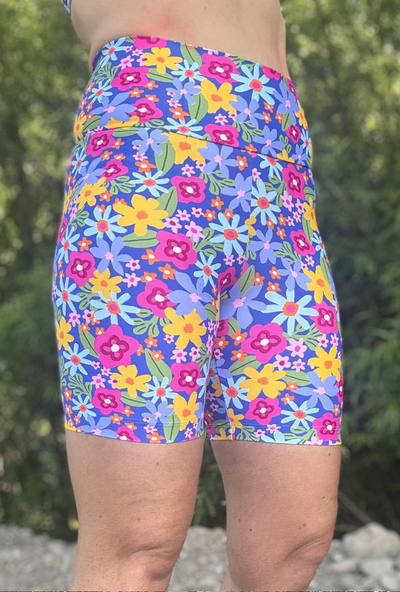 Colourful floral-patterned shorts worn by a person outdoors.