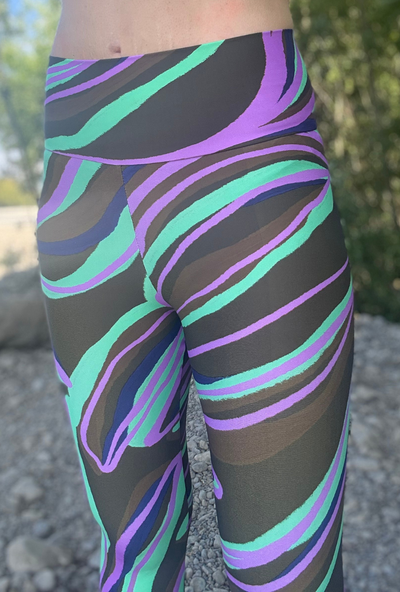 Leggings with a coloruful pattern worn by a person outdoors.